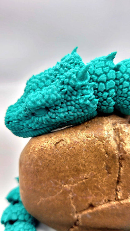 3D printed Basilisk articulated fidget toy.