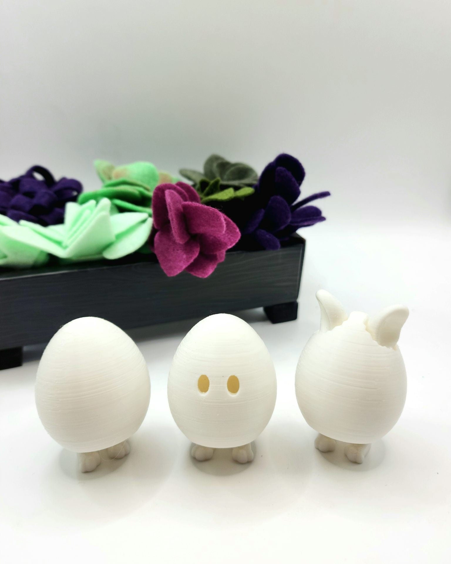 3D printed Easter eggs with collapsible legs. Able to stand and sit.