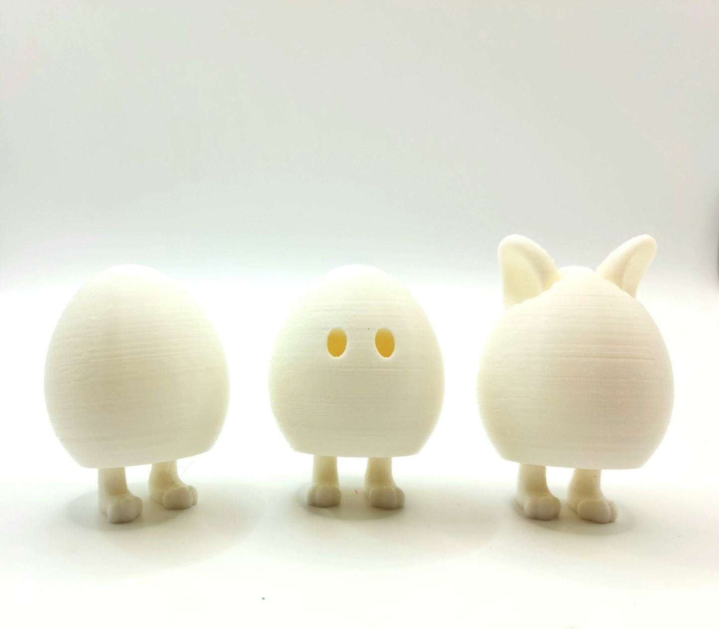 3D printed Easter eggs with collapsible legs. Able to stand and sit.