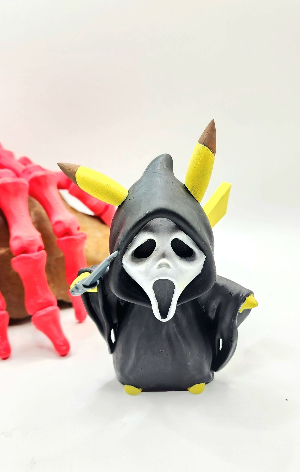 3D resin printed Pikachu cosplay as ghost face with knife. Halloween decoration.