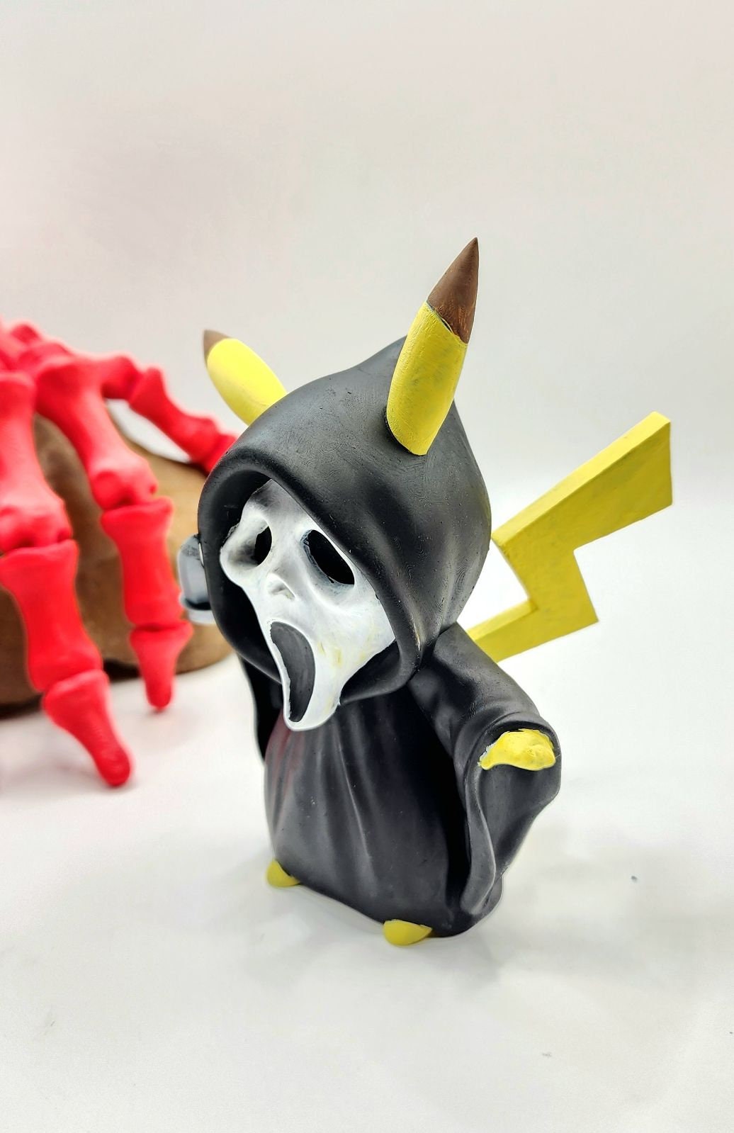 3D resin printed Pikachu cosplay as ghost face with knife. Halloween decoration.