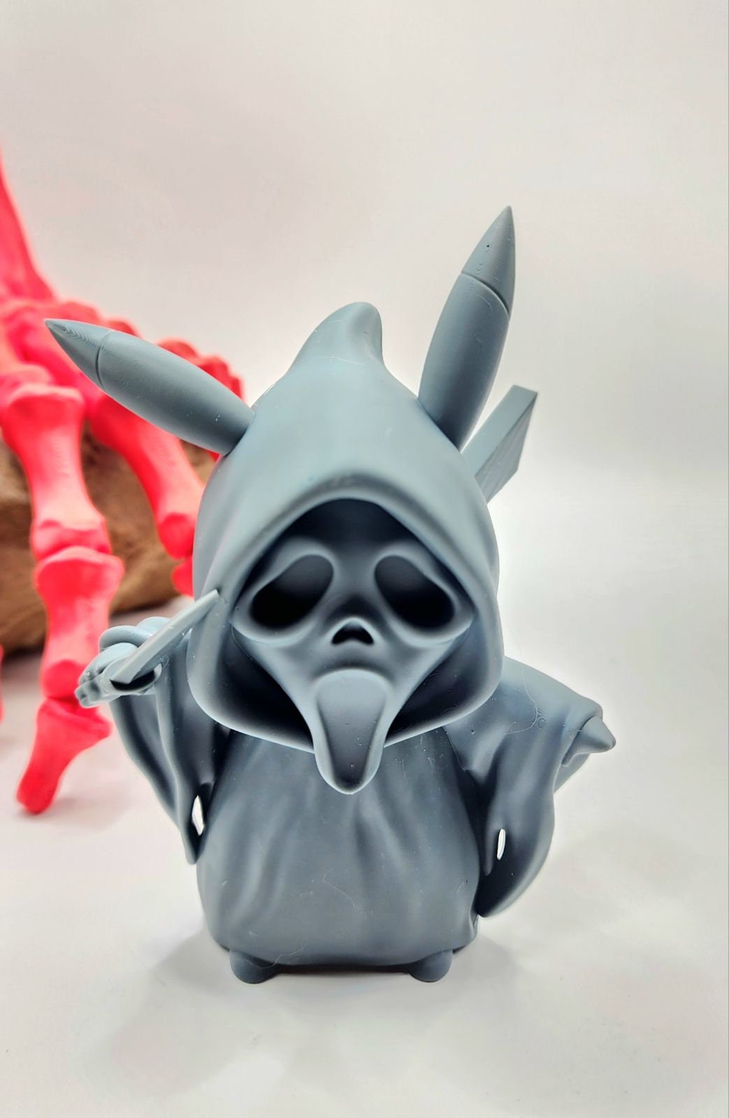 3D resin printed Pikachu cosplay as ghost face with knife. Halloween decoration.