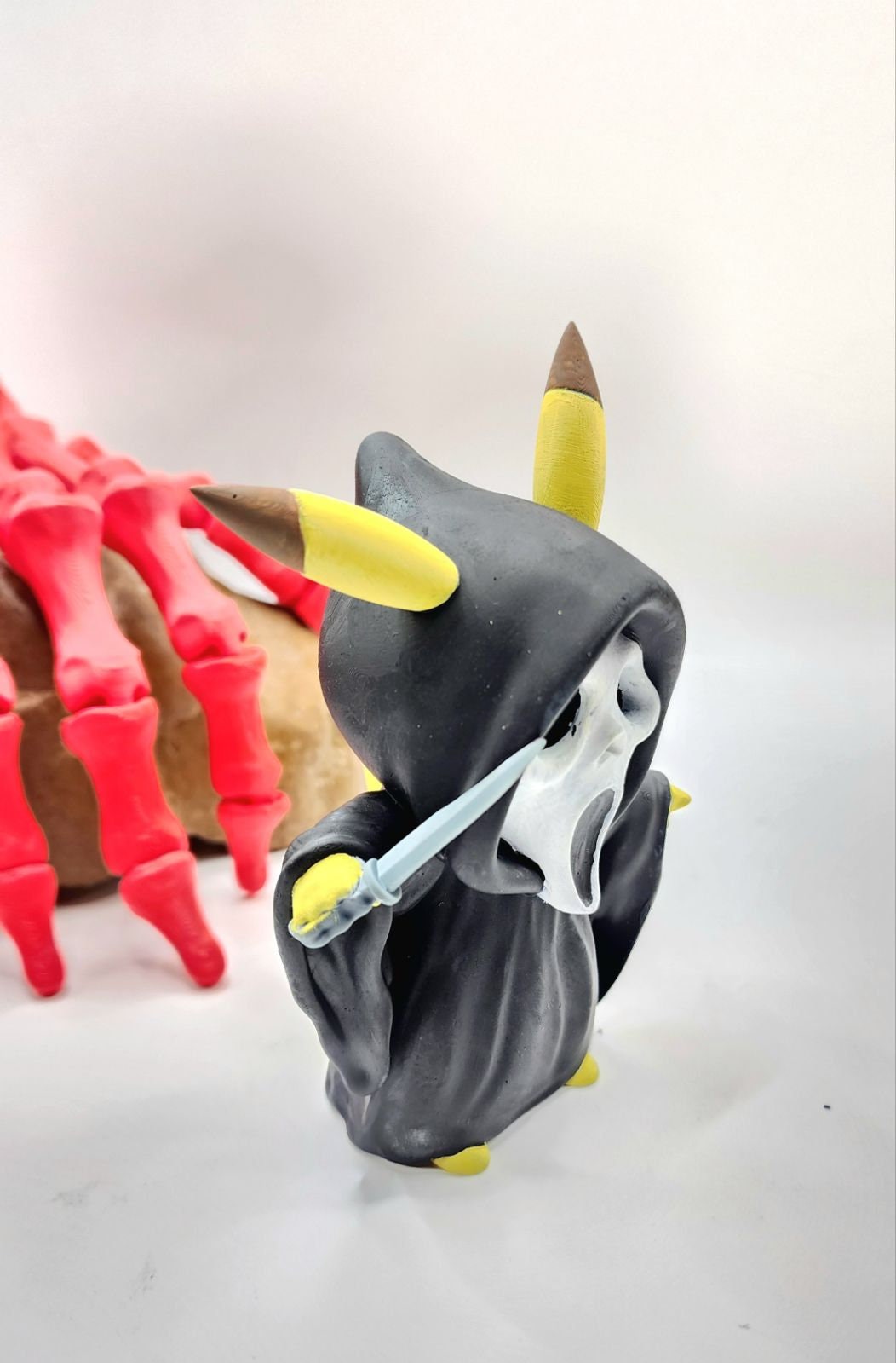 3D resin printed Pikachu cosplay as ghost face with knife. Halloween decoration.