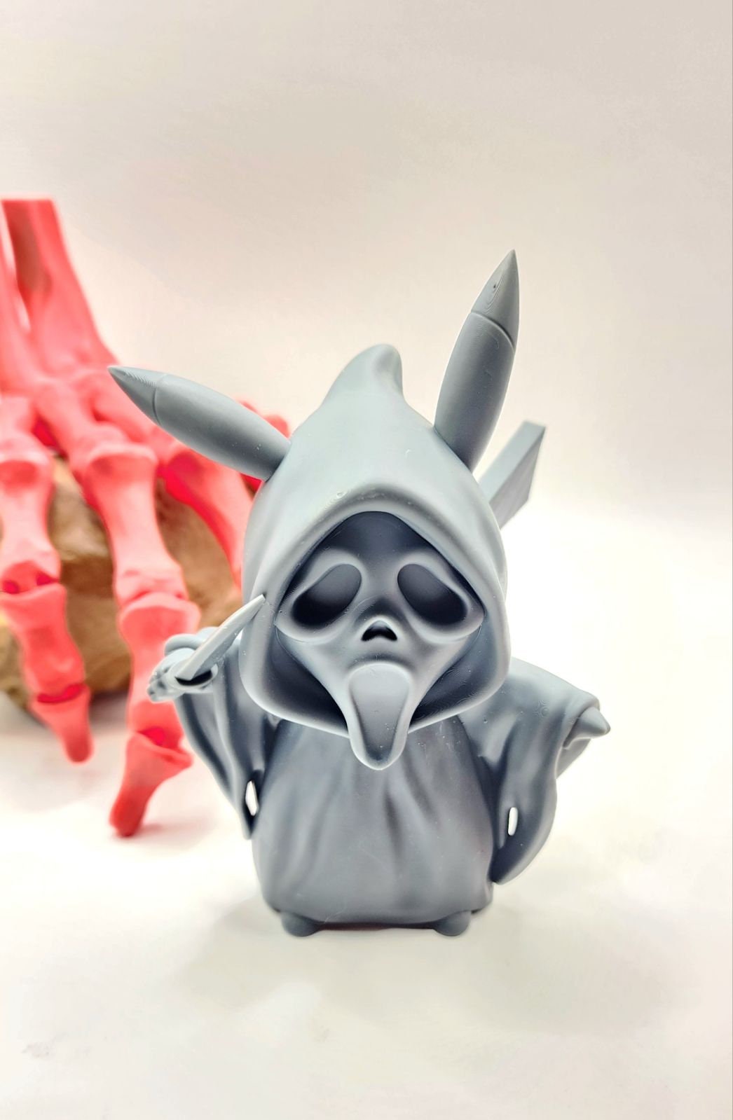 3D resin printed Pikachu cosplay as ghost face with knife. Halloween decoration.