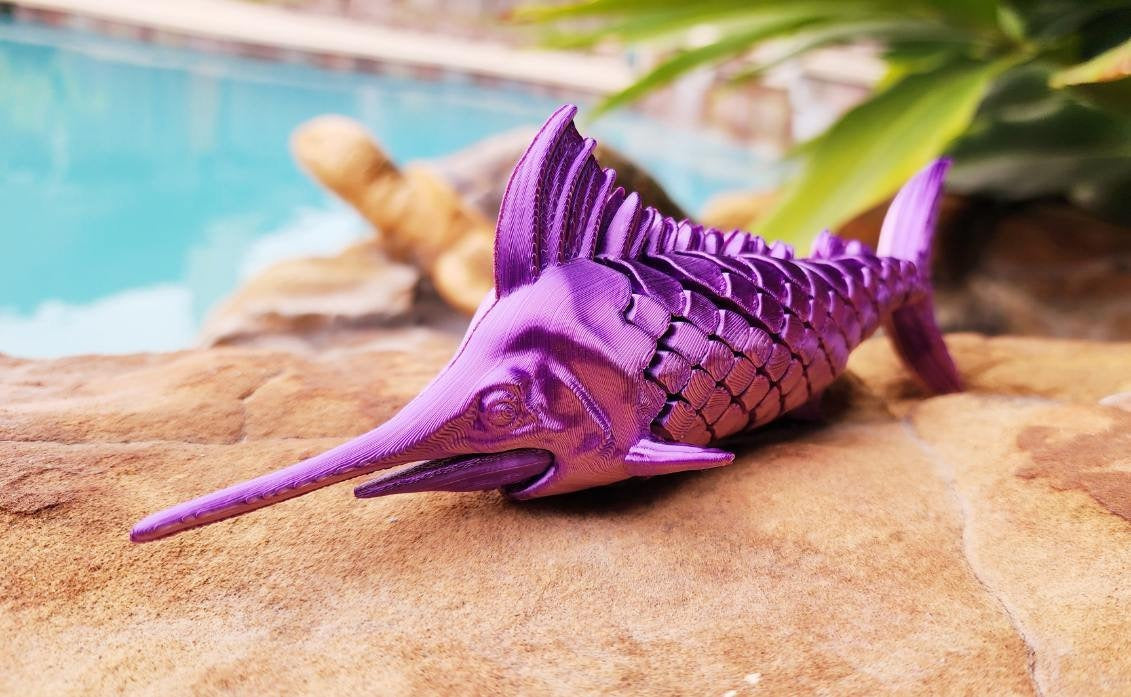 Articulated Marlin with its displaying plaque. Fidget toy, sensory toy.