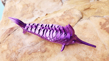 Articulated Marlin with its displaying plaque. Fidget toy, sensory toy.