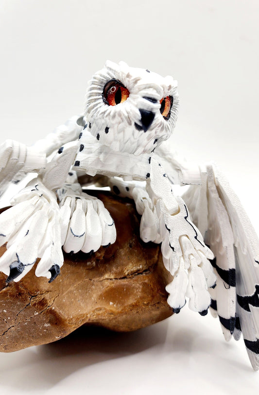 3D printed articulated Snow Gryphon fidget desk toy.