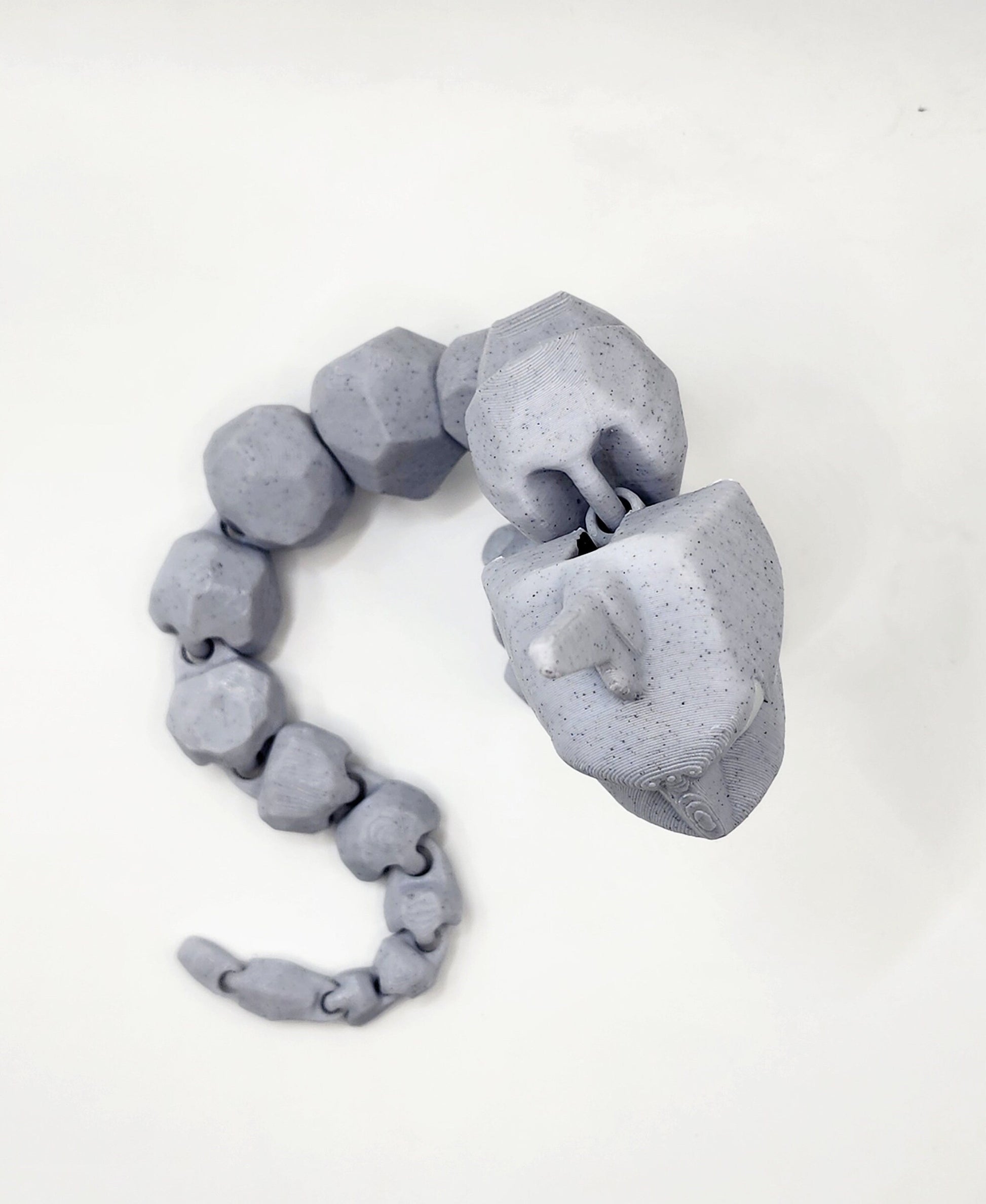 3D printed articulated Onix with articulated jaw. Fidget, Sensory toy.